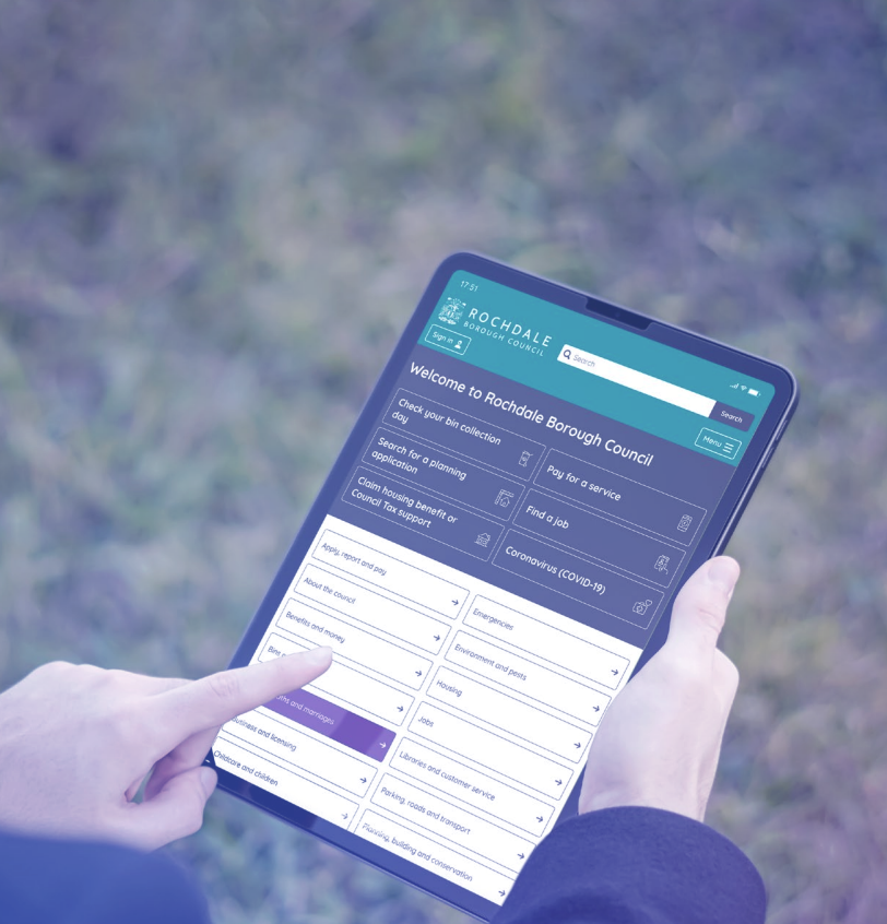 A person using the Rochdale Council's website on their tablet outdoors.