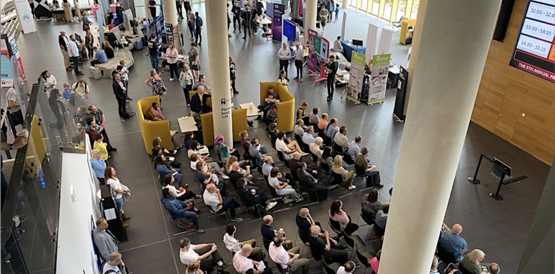 Group of people sat in a room looking at a presentation