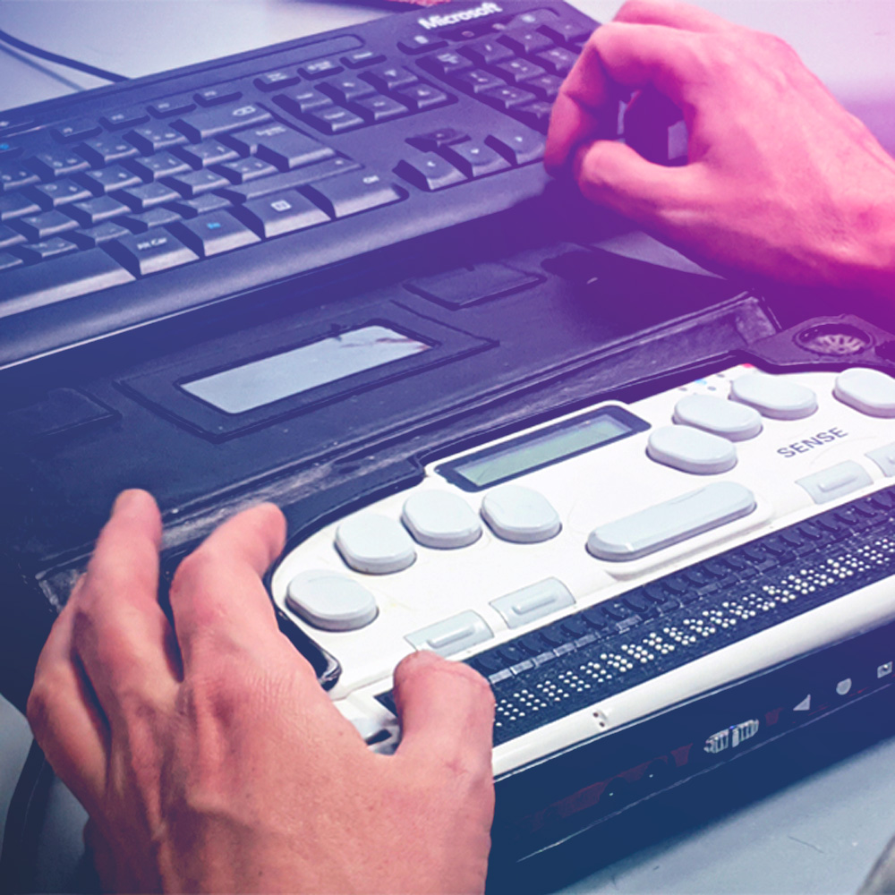 A blind person using a refreshable braille device